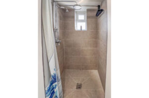 Waterfall shower in the ensuite off bedroom 1 at No 8 Sandhills
