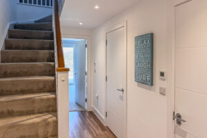 Hallway with stairs leading up to the first floor at No 2 Treglos.