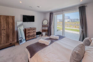 Master bedroom with super king bed, en suite shower room and storage, plus wall mounted TV