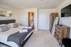 Master bedroom with super king bed, en suite shower room and storage, plus wall mounted TV