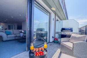 Balcony at No 2 Treglos with outdoor seating and barbeque.