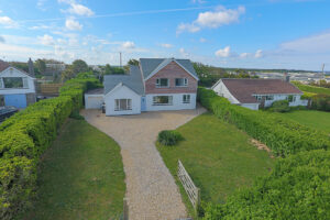 Exterior aerial view of the grassed front garden and parking at Whitehaven