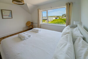 First floor king bedroom at White haven with large window to the front of the house with views towards Trevose Head