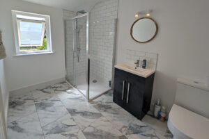 First floor bathroom at Whtehaven with shower cubicle, wash hand basin and toilet