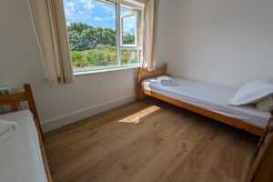 First floor twin bedroom with window to the rear garden at Whitehaven