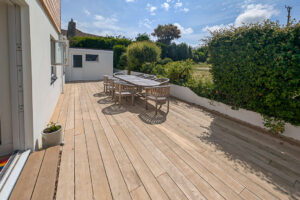 Rear decking area with outdoor dining furniture at Whitehaven