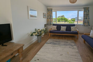 Lounge area with large window to the front garden at Whitehaven