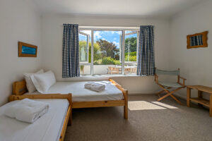 Ground floor twin bedroom at Whitehaven with window to rear patio area