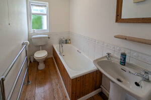 Ground floor bathroom with bath, hand held shower, toilet and wash hand basin at Whitehaven