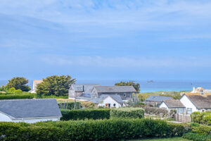 Aerial view over nearby properties out toward the ocean from Whitehaven
